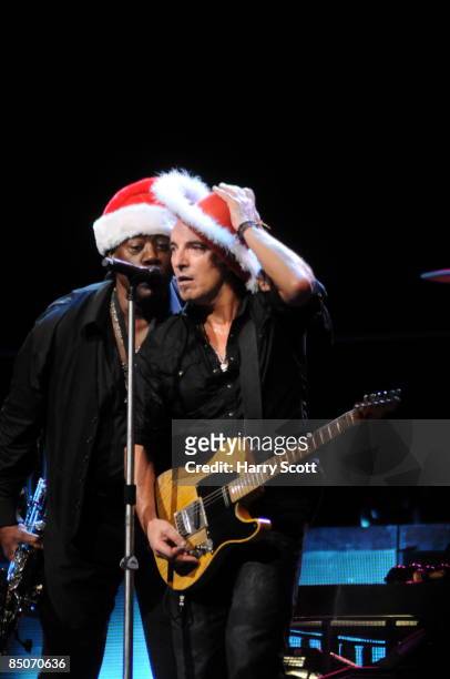 Photo of Clarence CLEMONS and Bruce SPRINGSTEEN; Bruce Springsteen and Clarence Clemons performing on stage at the Odyssey Arena in Belfast, wearing...