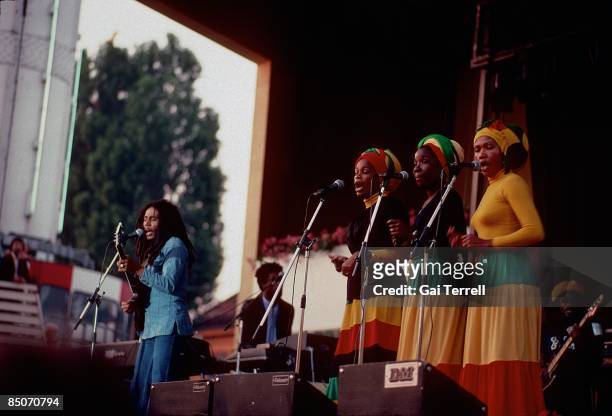 Photo of Bob MARLEY and WAILERS and I THREES; Bob Marley performing on stage with the I Threes