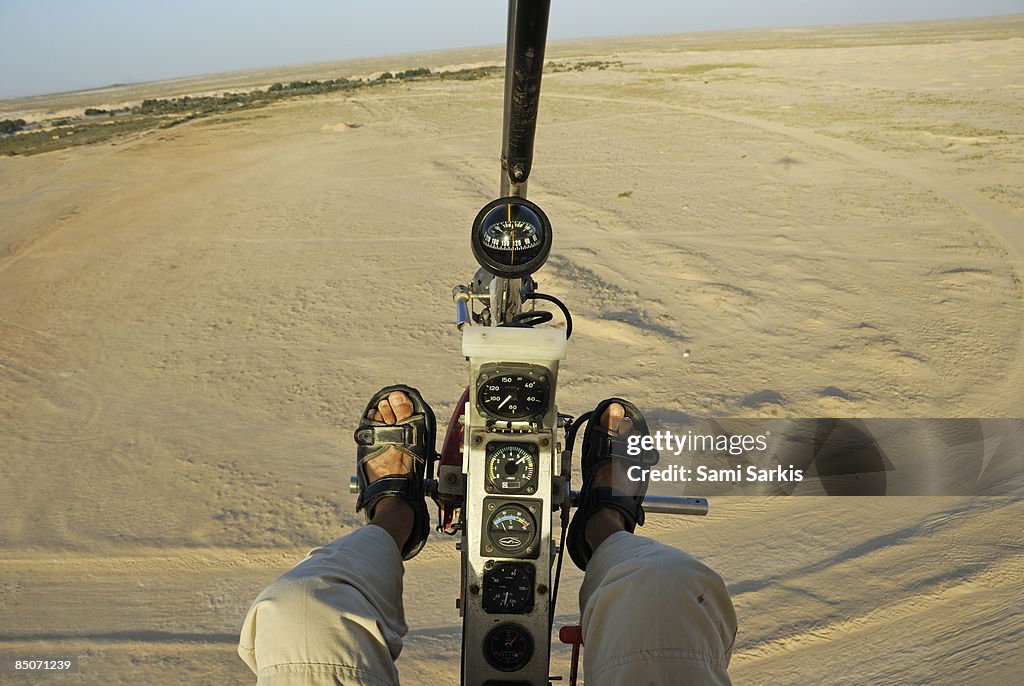 Microlite plane pilot, flying over Sahara desert