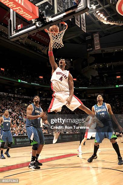 Chris Bosh of the Toronto Raptors drives the paint and throws down the dunk during a game against the Minnesota Timberwolves during a game on...