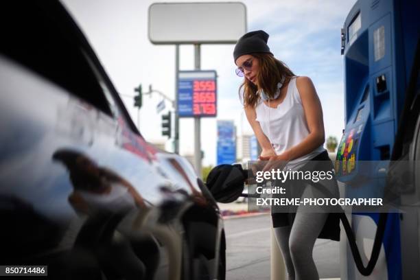 woman at the gas station - filling petrol stock pictures, royalty-free photos & images