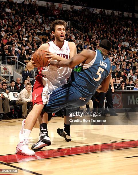 Andrea Bargnani of the Toronto Raptors drives baseline and collides with Craig Smith of the Minnesota Timberwolves during a game on February 24, 2009...