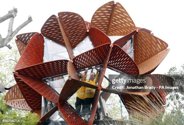 Workers adjust glass panels within the Waratah Studio, part of the Trailfinders Australian Garden presented by Flemings at the Chelsea Flower Show,...