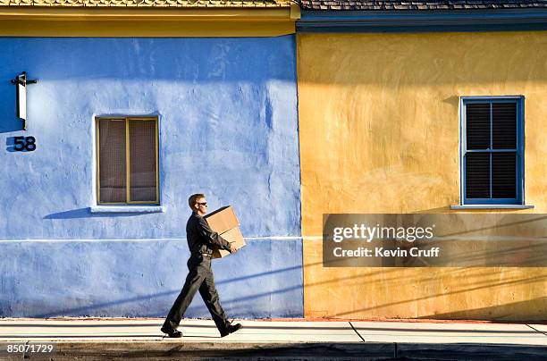 delivery man in hispanic neighborhood - consegna a domicilio foto e immagini stock