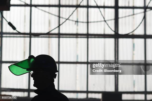 The silhouette of an employee is seen at the Lite Metals Co. Foundry in Ravenna, Ohio, U.S., on Wednesday, Sept. 20, 2017. The Lite Metals Co. Is a...