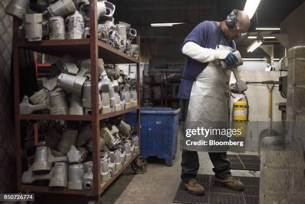 An employee sands castings at the Lite Metals Co. Foundry in Ravenna, Ohio, U.S., on Wednesday, Sept. 20, 2017. The Lite Metals Co. Is a magnesium...