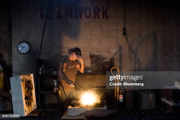 An employee uses a torch to clean a mold at the Lite Metals Co. Foundry in Ravenna, Ohio, U.S., on Wednesday, Sept. 20, 2017. The Lite Metals Co. Is...