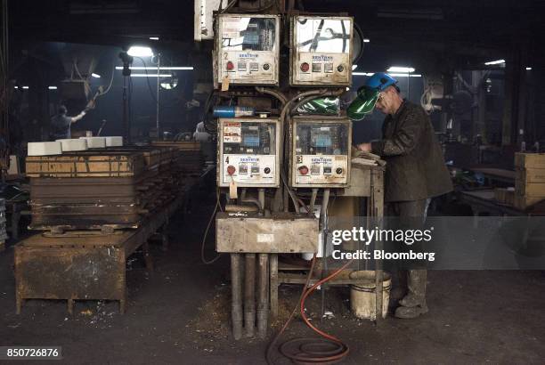 An employee records the results of a test taken from a sample of molten metal at the Lite Metals Co. Foundry in Ravenna, Ohio, U.S., on Wednesday,...