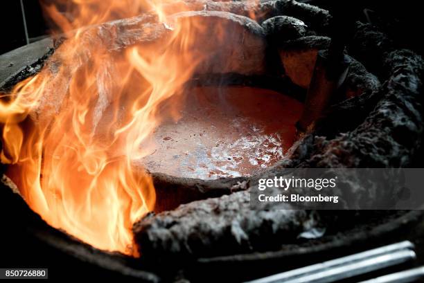 Molten aluminum sits inside a crucible at the Lite Metals Co. Foundry in Ravenna, Ohio, U.S., on Wednesday, Sept. 20, 2017. The Lite Metals Co. Is a...