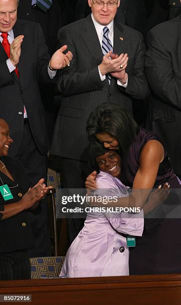 First Lady Michelle Obama embraces Ty'Sheoma Bethea of Dillon, SC, prior to US President Barack Obama's address to a Joint Session of Congress on...