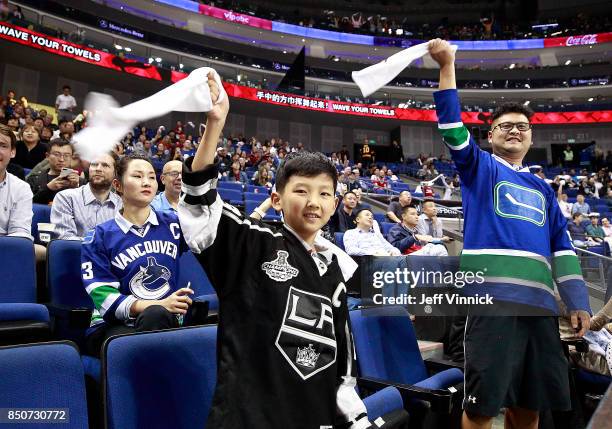 Fans wave rally towels as they cheer during the pre-season game between the the Los Angeles Kings and the Vancouver Canucks at the Mercedes-Benz...