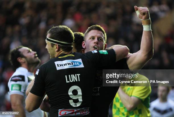 Huddersfield's Larne Patrick celebrates a try with Shaun Lunt during the Super League match at the Stobart Stadium Halton, Widnes. PRESS ASSOCATION...