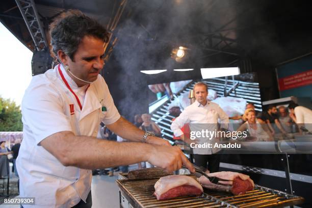 Well-known Brazilian chef Andre Lima de Luca grills meat within a show during the "Gastronomist 2017: World Culinary Cultures" at Sultanahmet Square...