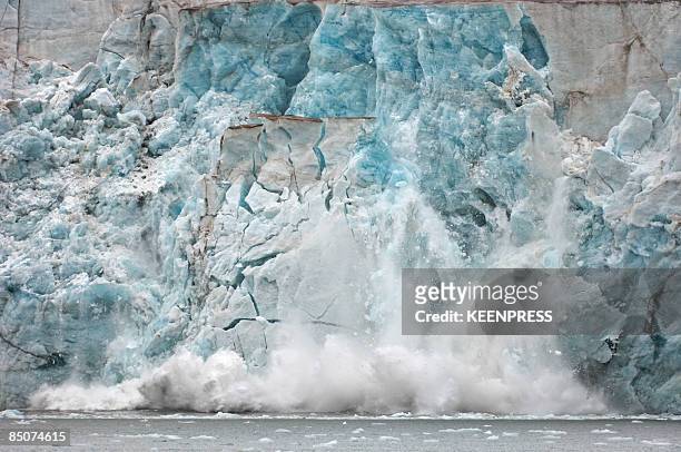 ice caving off a glacier - glacier collapsing ストックフォトと画像