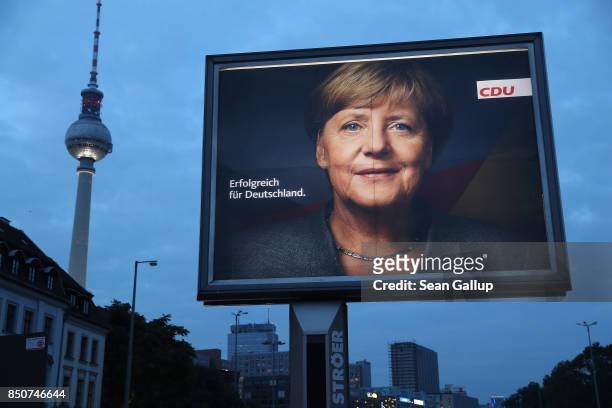 An election campaign billboard that shows German Chancellor and Christian Democrat Angela Merkel stands near the broadcast tower at Alexnderplaz on...