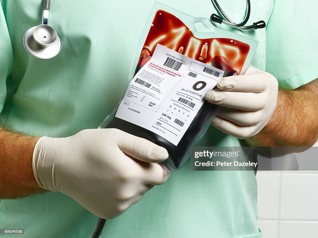 Doctor/ Nurse holding blood bag.