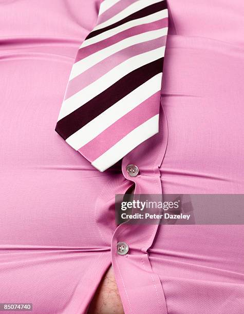 obese man with pink shirt gaping open. - too small stockfoto's en -beelden