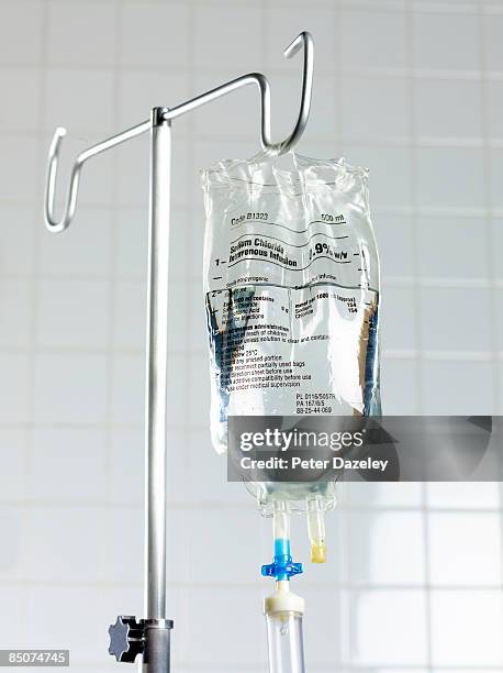 saline drip on stand in hospital. - iv infusion stock-fotos und bilder