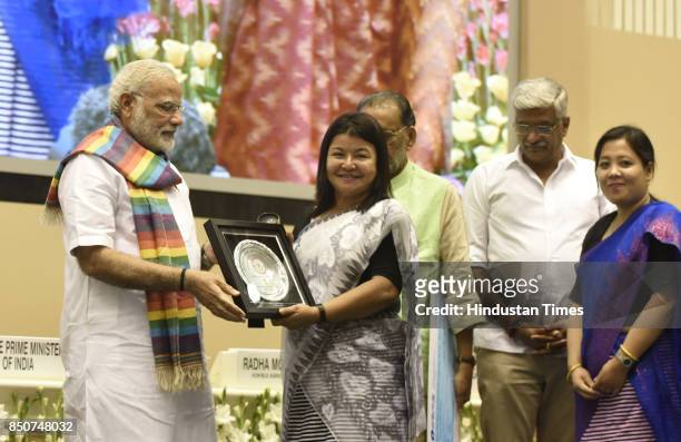 Prime Minister Narendra Modi releases the book on Indian Co-operative Movement at the birth centenary celebration of Laxman Rao Inamdar and Sahakar...