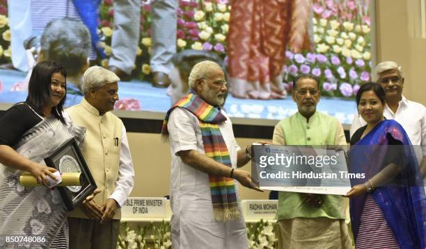 Prime Minister Narendra Modi distributes the awards to co-operative societies, at the birth centenary celebration of Laxman Rao Inamdar and Sahakar...
