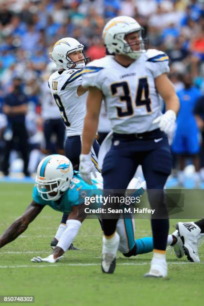 Younghoe Koo kicks a fieldgoal as Drew Kaser of the Los Angeles Chargers holds during the second half of a game against the Miami Dolphins at StubHub...