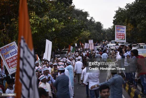 Workers and activists form a human chain to protest against Prime Minister Narendra Modi and Delhi government for the recently hiked petrol and...