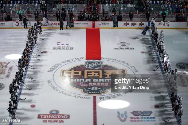 Players line up for the opening ceremony during a pre-season National Hockey League game between the Vancouver Canucks and the Los Angeles Kings at...