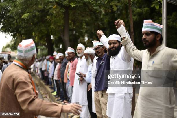 Workers and activists form a human chain to protest against Prime Minister Narendra Modi and Delhi government for the recently hiked petrol and...