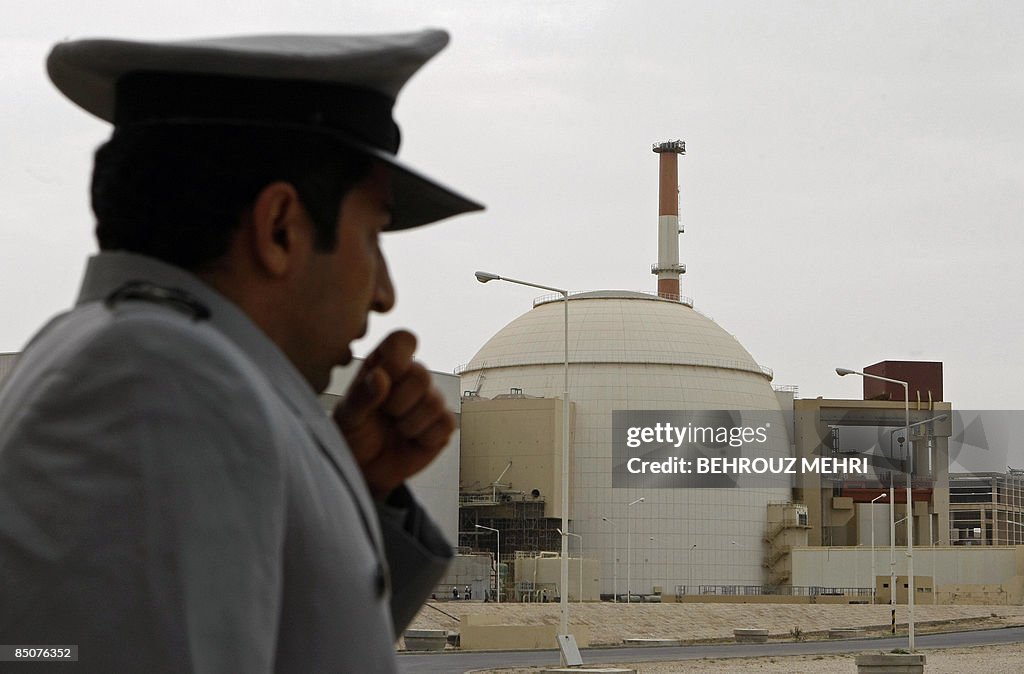 An Iranian security guard stands outside