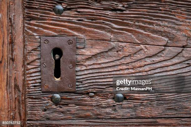 keyhole of the wooden doorway of a medieval church - key hole stock pictures, royalty-free photos & images