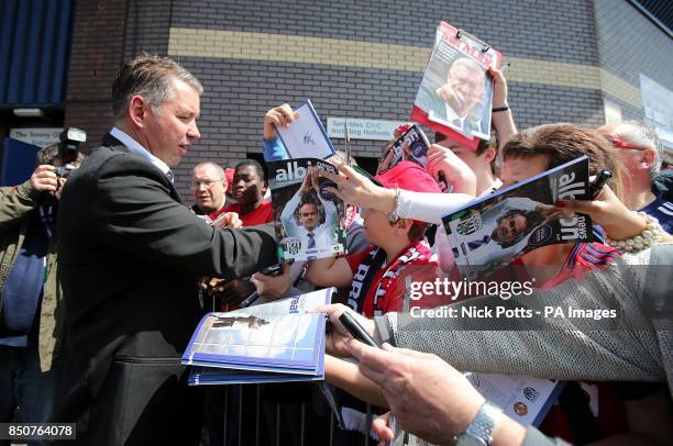 Peterborough United manager Darren Ferguson, son of Manchester United manager Sir Alex Ferguson signs autographs for fans at The Hawtorns before the...