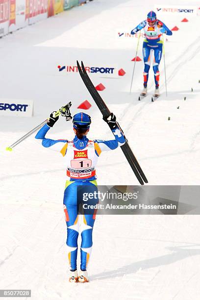 Aino Kaisa Saarinen of Finland celebrates as teammate, Virpi Kuitunen approaches the finish line to win the Gold medal during the Ladies Cross...