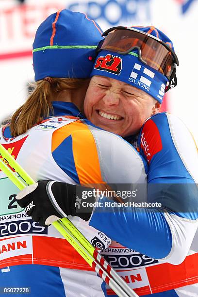 Virpi Kuitunen of Finland is congratulated by teammate Aino Kaisa Saarinen as she crosses the finish line to win the Gold medal during the Ladies...