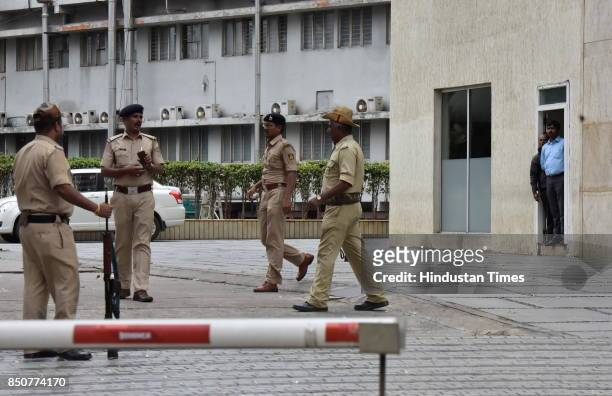 Police stand on guard as Income Tax officials raid at Coffee Day Square headquarters of Cafe Coffee Day during the raid at the properties of VG...