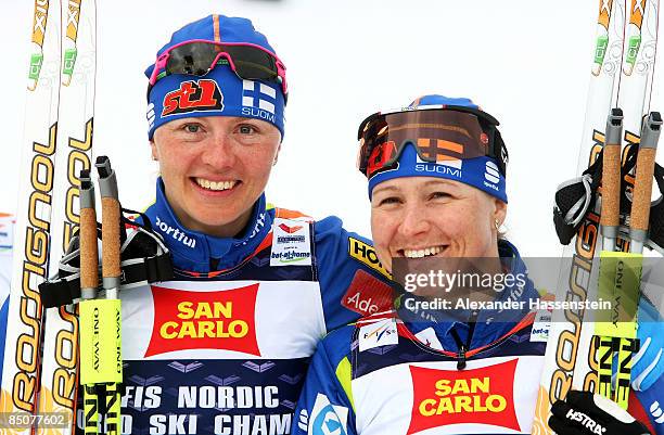 Virpi Kuitunen of Finland and Aino Kaisa Saarinen celebrate after winning the Gold medal during the Ladies Cross Country Team Sprint Final at the FIS...