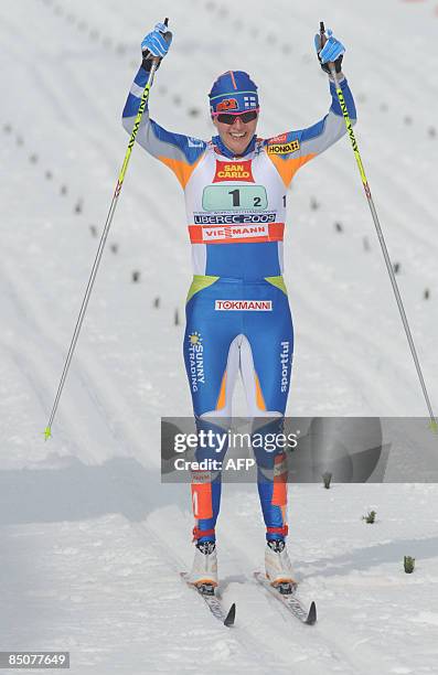 Virpi Kuitunen of Finland celebrates her victory as she crosses the finish line during the women's team sprint classic event of the Nordic Skiing...