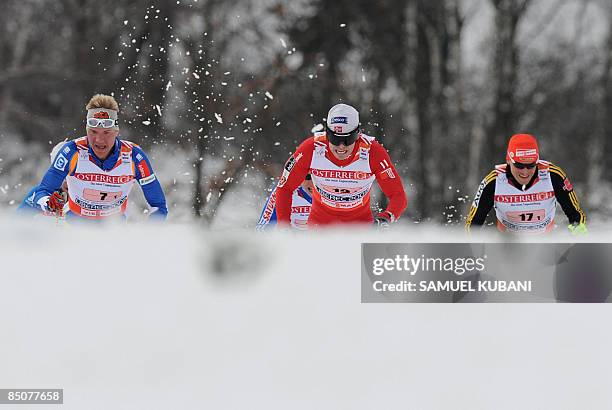 Johan Kjoelstad Norway , Ville Nousiainen of Finland and Tobias Angerer of Germany compete during the men's cross country team sprint at the Nordic...