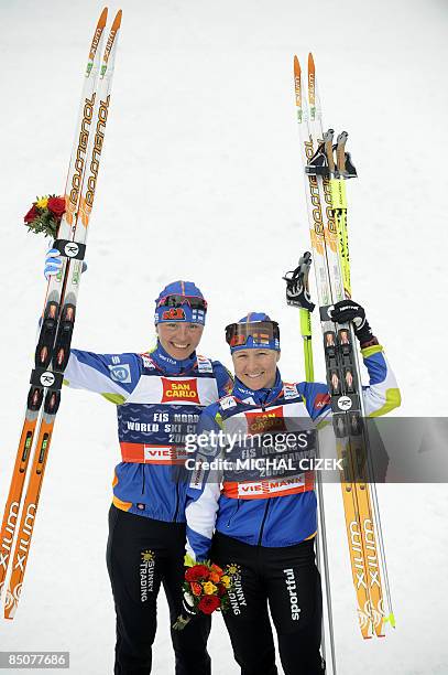 Finlands Aino Kaisa Saarinen and her compatriot Virpi Kuitunen pose for media after the women's Team Sprint Classic event of the Nordic Skiing World...