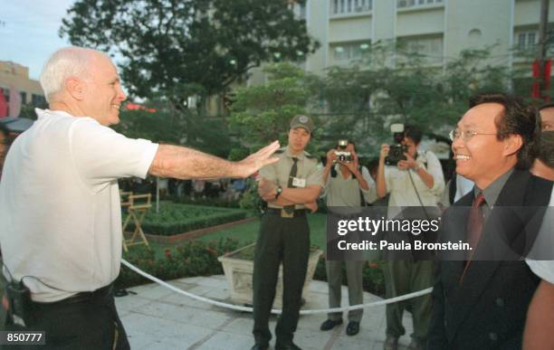 Sen. John McCain , left, waves to his supporters before he is interviewed by the Today Show in Ho Chi Minh City, Vietnam April 28, 2000. McCain, who...