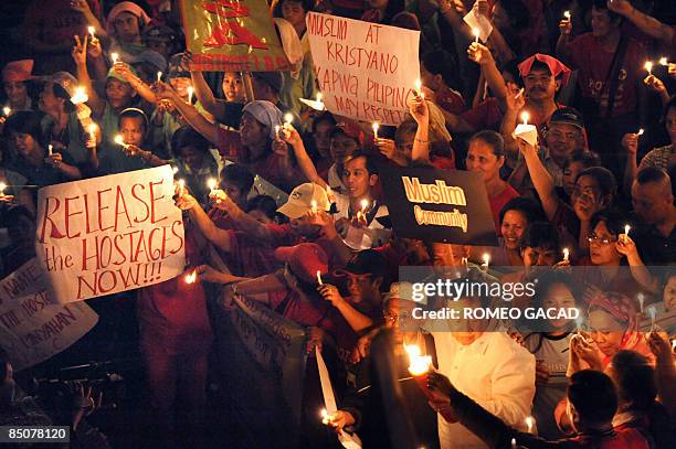 Red Cross volunteers and sympathizers led by Philippine National Red Cross chairman Senator Richard Gordon hold a candlelight prayer rally in Quezon...