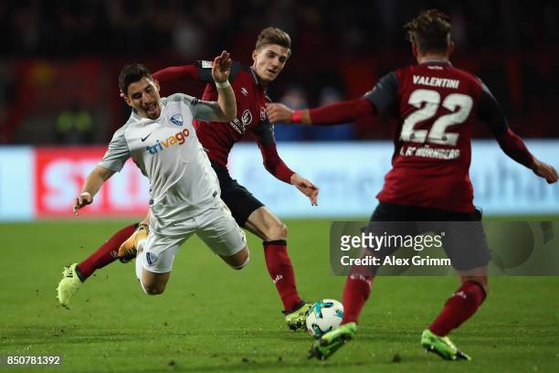 Danilo Soares of Bochum is challenged by Lucas Hufnagel and Enrico Valentini of Nuernberg during the Second Bundesliga match between 1. FC Nuernberg...