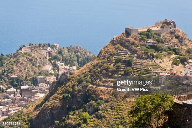 View of the Greek Theatre, Saracen Castle and town of Taormina, from Castelmola, Sicily, Italy.