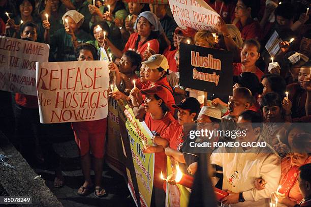 Red Cross volunteers and sympathizers led by Philippine National Red Cross chairman Senator Richard Gordon hold a candlelight prayer rally in Quezon...