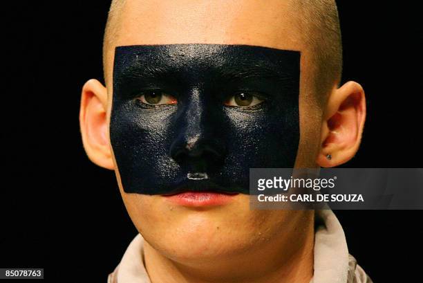 Model wears face paint during a show by fashion designer Christopher Shannon during the Autumn/Winter 2009 show on the last day of London Fashion...