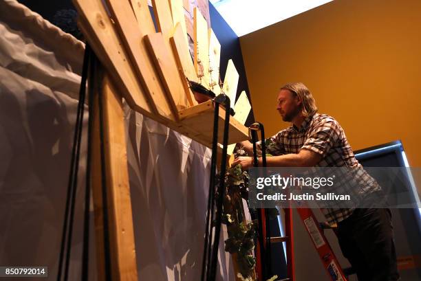 Artist Peter Foucaulton works on his "Ghost Ship" art installation at the Oakland Museum of California on September 21, 2017 in Oakland, California....