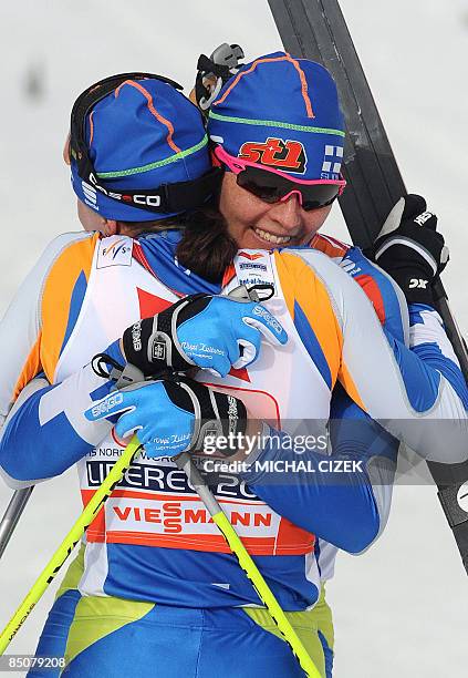 Aino Kaisa Saarinen of Finland celebrates with her teammate Virpi Kuitunen after their victory in the women's team sprint classic event of the Nordic...