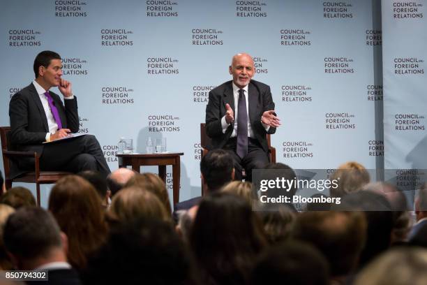 Ashraf Ghani, Afghanistan's president, right, speaks as David Miliband, president and chief executive officer of the International Rescue Committee ,...