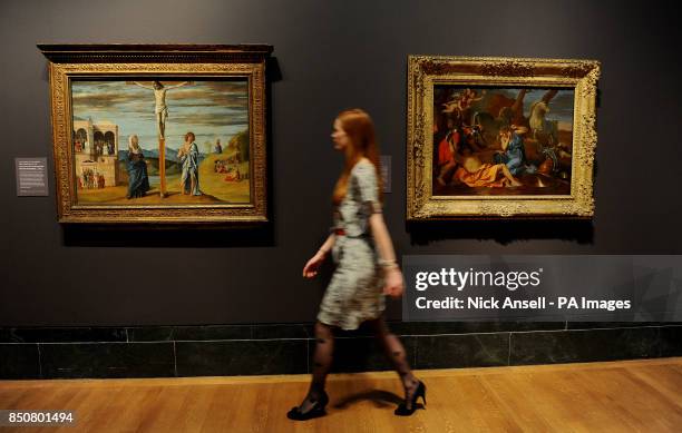 Gallery staff member, Katie Carder walks past Christ on the Cross with the Virgin and St John the Evangelist by Giovanni Battista Cima and Tancred...