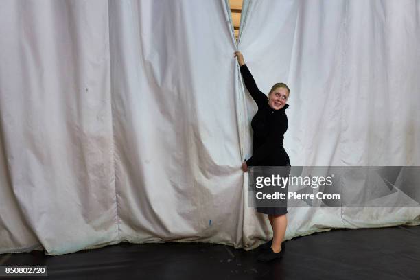 Worker holds the curtains closed on stage before a theater representation on September 21, 2017 in Minsk, Belarus. Young Theater artists from...