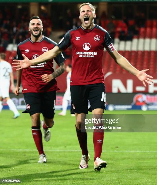 Hanno Behrens of Nuernberg celebrates his team's second goal with team mate Mikael Ishak during the Second Bundesliga match between 1. FC Nuernberg...